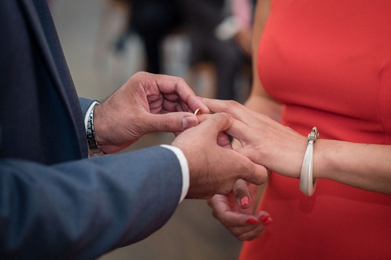 groom-putting-ring-on-brides-finger